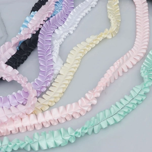 Close-up of 2.5cm wide ruffled polyester satin ribbons in various soft pastel colors