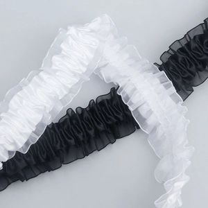 Detail of 4cm wide pleated elastic lace trim in black and white satin with organza