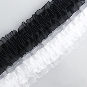 Detail of 4cm wide elastic lace trim with black and white satin pleats for DIY crafts