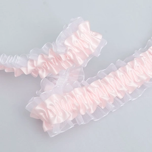 Detail of 4cm pink satin and white lace trim with elastic ruffles for DIY sewing and crafts