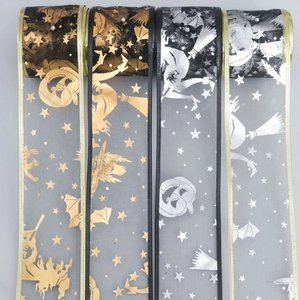 Detail of Halloween ribbons with metallic witch and pumpkin prints on sheer mesh