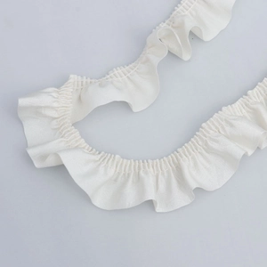 Close-up of 3cm white pleated cotton lace trim with dense ruffles for DIY sewing