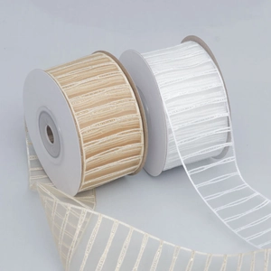 Detail of sheer striped ribbon with silver metallic threads for DIY crafts and gift wrapping