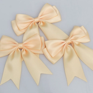 Detailed view of champagne satin double-layered bow with dovetail ribbons for DIY crafts