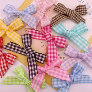 Close-up of handmade gingham ribbon bows in multiple colors for DIY gift box decor
