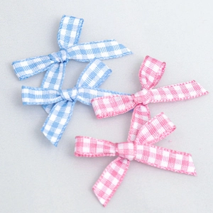 Detail of pink and light blue plaid ribbon bows for gift wrapping and DIY crafts