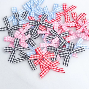 Macro detail of assorted multi-color gingham plaid handmade bows for gift wrapping decoration