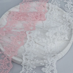 Detail view of 13cm floral lace trim with embroidered pink and white roses on mesh