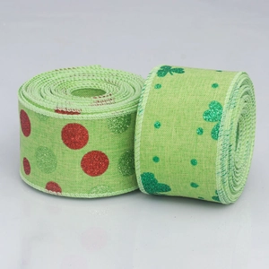 Green St. Patrick's Day ribbons with glitter clovers and polka dots on wired fabric