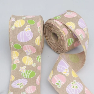 Detail of burlap Easter ribbon with colorful egg patterns and wired edges for gift decor