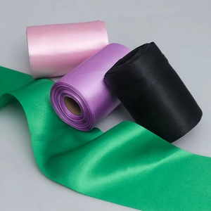 Satin ribbon rolls in pink, purple, green and black colors for gift wrapping and hair DIY