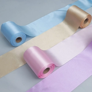 Detail showing smooth satin ribbons in pastel blue, gold, pink, and lavender colors