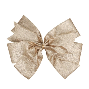 Close-up of golden glitter fabric Christmas bow ornament for trees and holiday wreaths