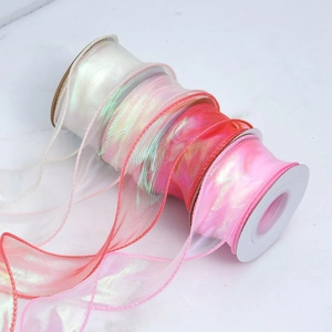 Close-up of iridescent organza ribbon with gradient pink shades and pearlescent finish