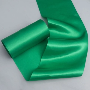 Emerald green satin ribbon roll with high glossy finish for wedding chair decor and gift wrapping