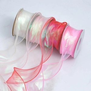 Iridescent organza ribbon rolls in pearl white and pink for gift wrapping and hair decor