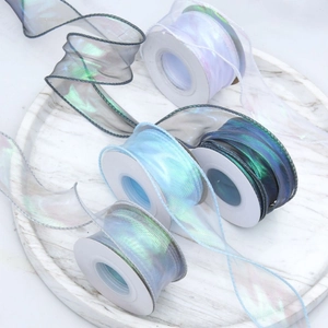 Iridescent organza ribbon rolls in cool tones for gift wrapping and DIY crafts