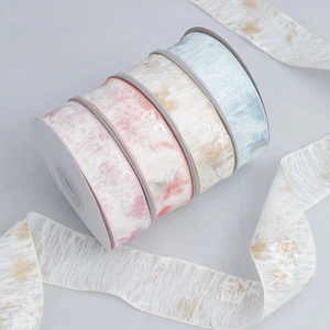 Macro detail of floral print chiffon ribbons with translucent mesh texture in four soft colors