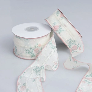 Close-up of double-sided lace floral ribbon with textured dots and pink scalloped edges
