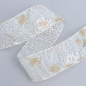 Semi-transparent ivory floral ribbon with gold rose patterns and pleated texture for DIY crafts
