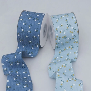 Detail of floral printed ribbons in navy and light blue for DIY hair bows and gift wrapping