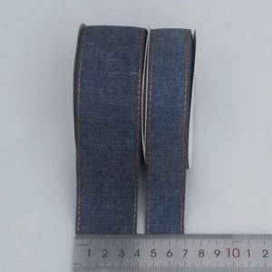 Blue denim ribbon with orange stitching and measurement ruler for DIY hair accessories