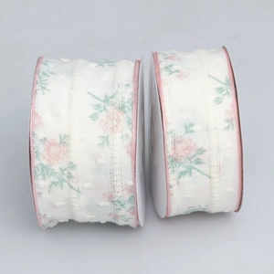 Detailed texture of floral lace ribbon with pink rose pattern and dotted weaving surface