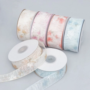 Semi-transparent chiffon ribbons with floral patterns on rolls for DIY gift wrapping