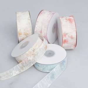 Detail of translucent organza ribbon rolls with floral watercolor patterns for DIY crafts