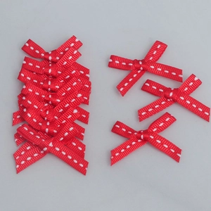Detailed close-up of 6mm red grosgrain bows with white topstitching for DIY gift wrapping