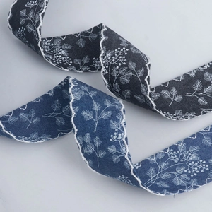 Detail of blue wave-edged fabric ribbon with white floral print for DIY gift wrapping