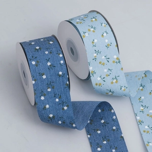 Detail of floral printed fabric ribbons in dark and light blue with woven texture