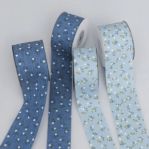 Detailed macro of four floral printed fabric ribbons with blue and denim textures
