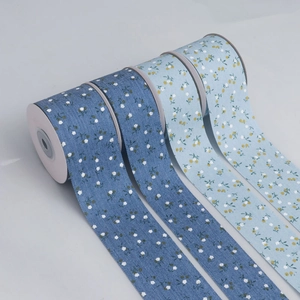 Detail view of four blue floral cotton ribbons with delicate canvas texture for DIY crafts