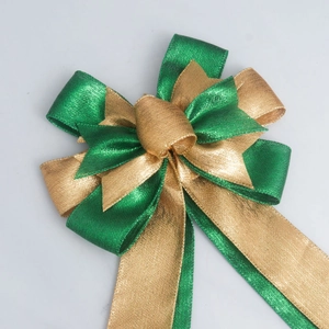 Close-up of a dark green and gold layered glitter ribbon bow for festive gift decorations