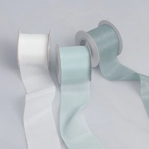 Macro detail of pearlescent organza ribbons in white, mint and grey blue colors