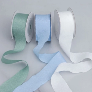Close-up of matte polyester ribbons in green, blue, and white with elegant wrinkled texture