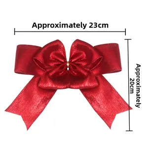 Detail view of 23x20cm red sequin Christmas bow decoration with golden center tie
