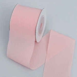 Translucent light pink chiffon ribbon roll with frayed edges for DIY gift wrapping