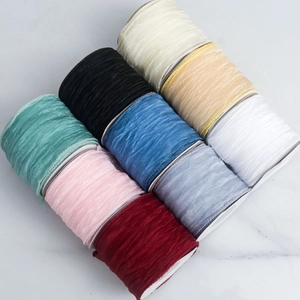 Macro shot of pleated sheer chiffon ribbon rolls in nine colors for floral craft DIY