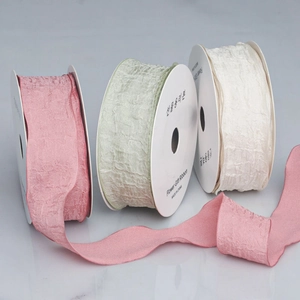 Close-up of 4cm ruffled chiffon ribbon rolls in pink, green, and cream for gift wrapping