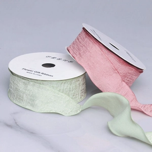Detailed view of pink and light green ruffled organza ribbons for gift packaging