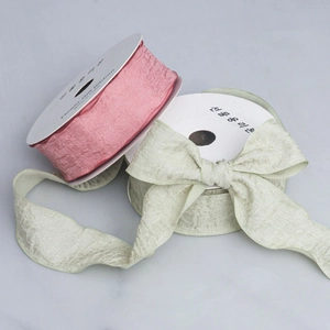 Close-up of pink and green ruffled ribbons with pleated texture for gift wrapping