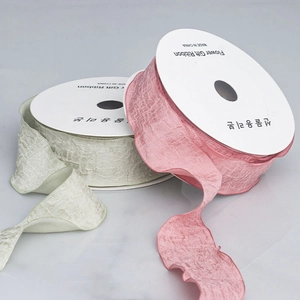 Rolls of 4cm ruffled chiffon ribbon in soft pink and light green for gift packaging