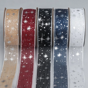 Detail view of five colors of starry sky sheer ribbons with silver stamped patterns