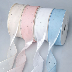Macro shot of semi-transparent chiffon ribbons with rhinestones for gift packaging