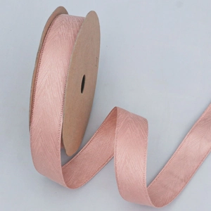 Pink herringbone ribbon with silk sheen on a kraft paper roll for DIY flower gift wrapping