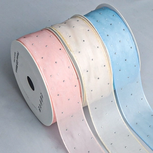 Detailed view of pink, white, and blue semi-transparent chiffon ribbons with silver rhinestones