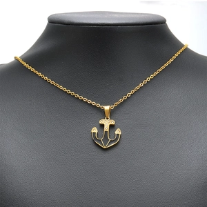 Polished gold anchor pendant necklace with black enamel inlay and sparkling crystals