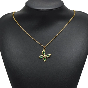 Elegant gold butterfly necklace featuring four green marquise gemstones on a slim gold chain